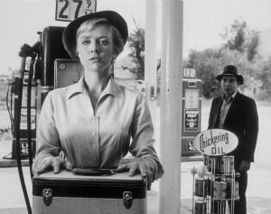 Inger Stevens, as driver Nan Adams, and Leonard Strong, as the titular hitchhiker, in a still from "The Twilight Zone" episode based on "The Hitch-Hiker" (courtesy Wikimedia Commons)